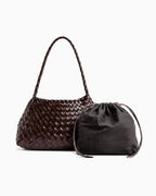 A coffee-colored woven leather shoulder bag with a braided top handle, shown next to a matching cotton drawstring pouch