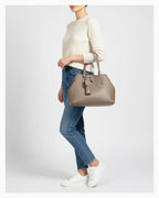 A woman in a casual outfit with a Genuine Leather  Beige Grey Tote Bag with Spacious Interior and Detachable Leather Lipstick Pouch