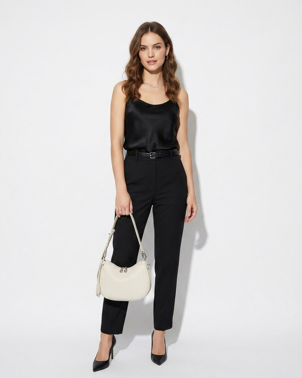 Woman wearing a black satin top and black pants with an Off-White Genuine Leather Crescent Shoulder Bag with Adjustable Strap