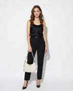 Woman wearing a black satin top and black pants with an Off-White Genuine Leather Crescent Shoulder Bag with Adjustable Strap