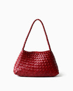 A wine-red woven leather shoulder bag with a braided top handle