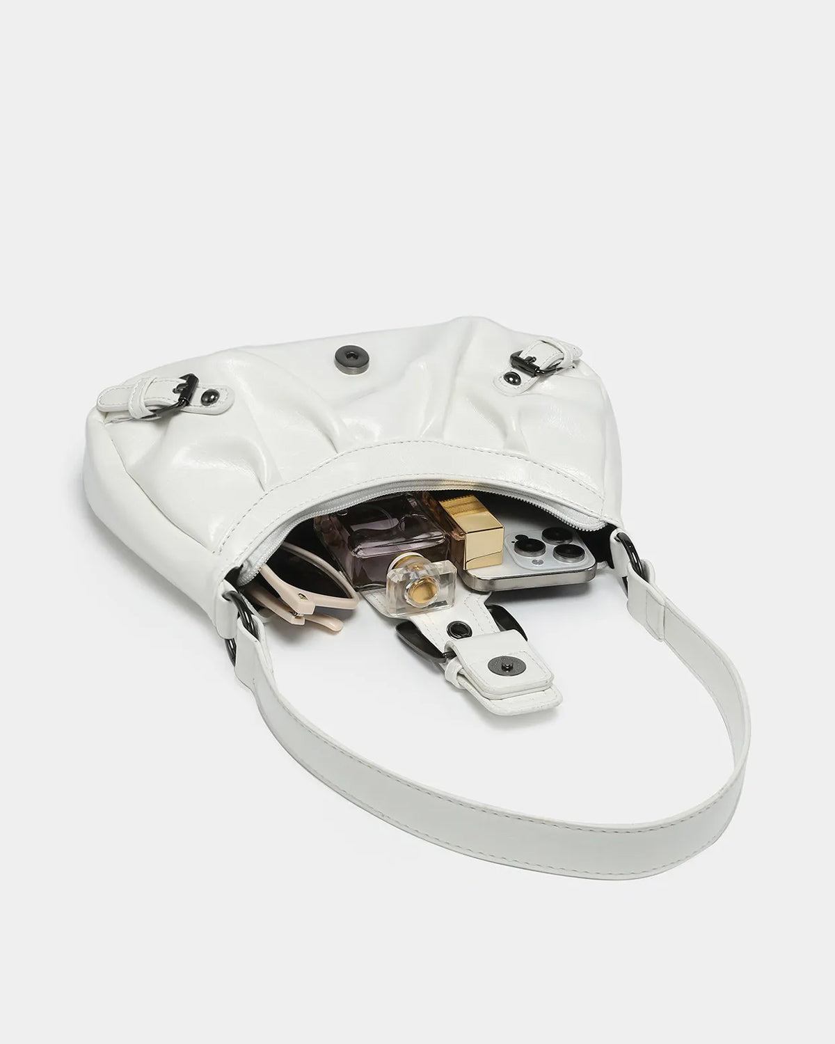 What fits inside the Women's fashionable Vegan Leather Shoulder White Bag with Buckle Details