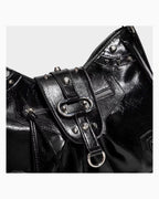 Leather texture and hardware details Black Studded Y2K Statement Vegan Leather Handbag with adjustable single strap