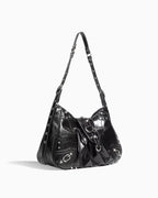 Side view of the Black Studded Y2K Statement Vegan Leather Handbag with an adjustable single strap