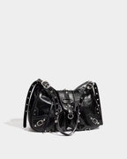Side view of the Black Studded Y2K Statement Vegan Leather Handbag with an adjustable single strap
