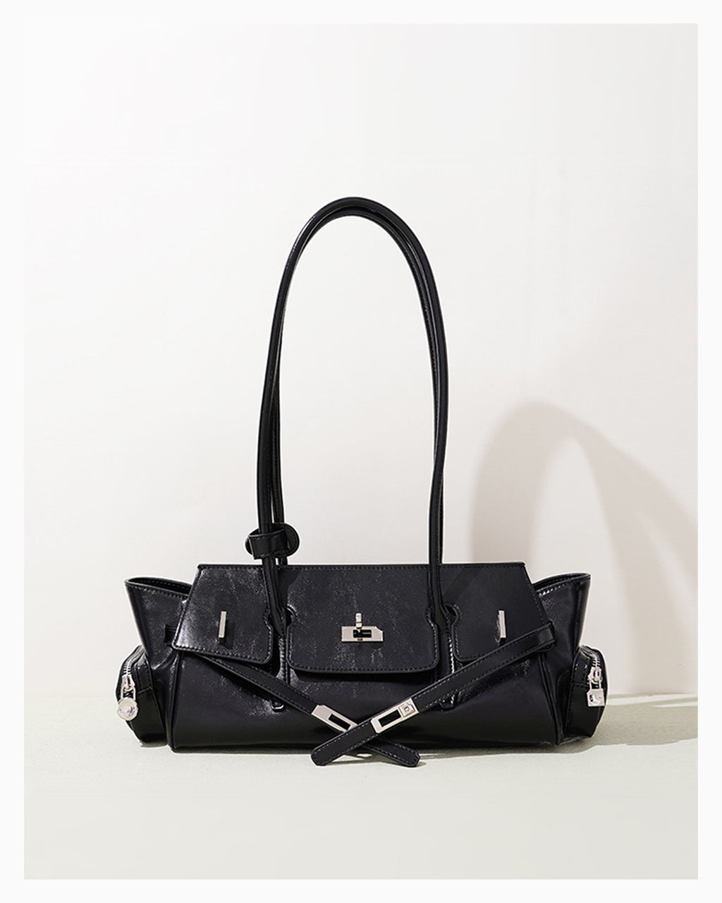 Woman's Genuine Leather Black Shoulder Baguette Bag with zippered side pockets and turn-lock closure