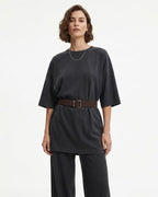 A woman modeling a dark charcoal gray short-sleeve top with a coffee-colored Suede Belt with a silver rectangular buckle, paired with matching dark gray wide-leg pants