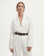 A woman modeling a white long-sleeve blazer-style top with matching white trousers and a coffee-colored genuine Suede leather Belt with a silver rectangular buckle