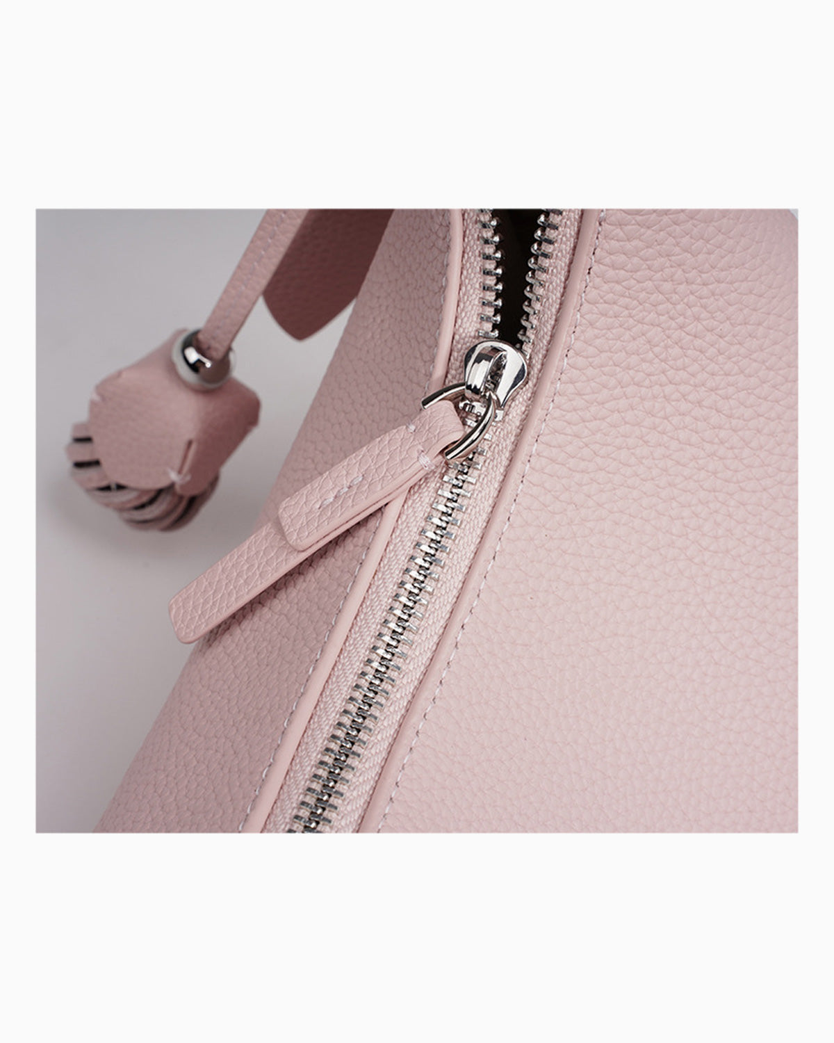 Zipper details of the Genuine Leather Crescent Baguette Shoulder Bag in a Peach Pink Color
