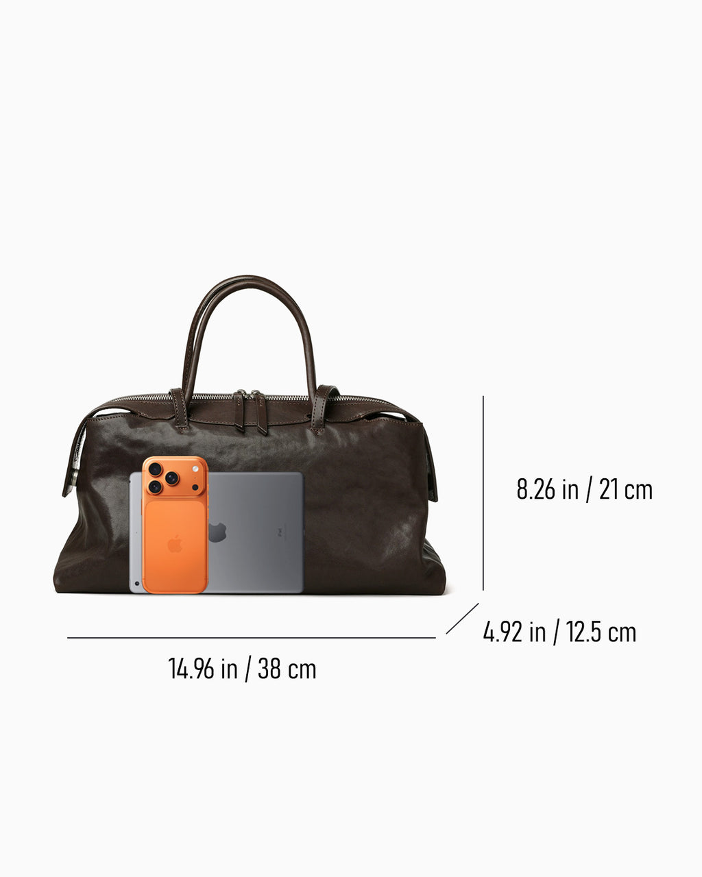 Dimensions of the Large Coffee-brown Leather Pillow Handbag with phone and tablet next to it for scale | BUCKLE Collective