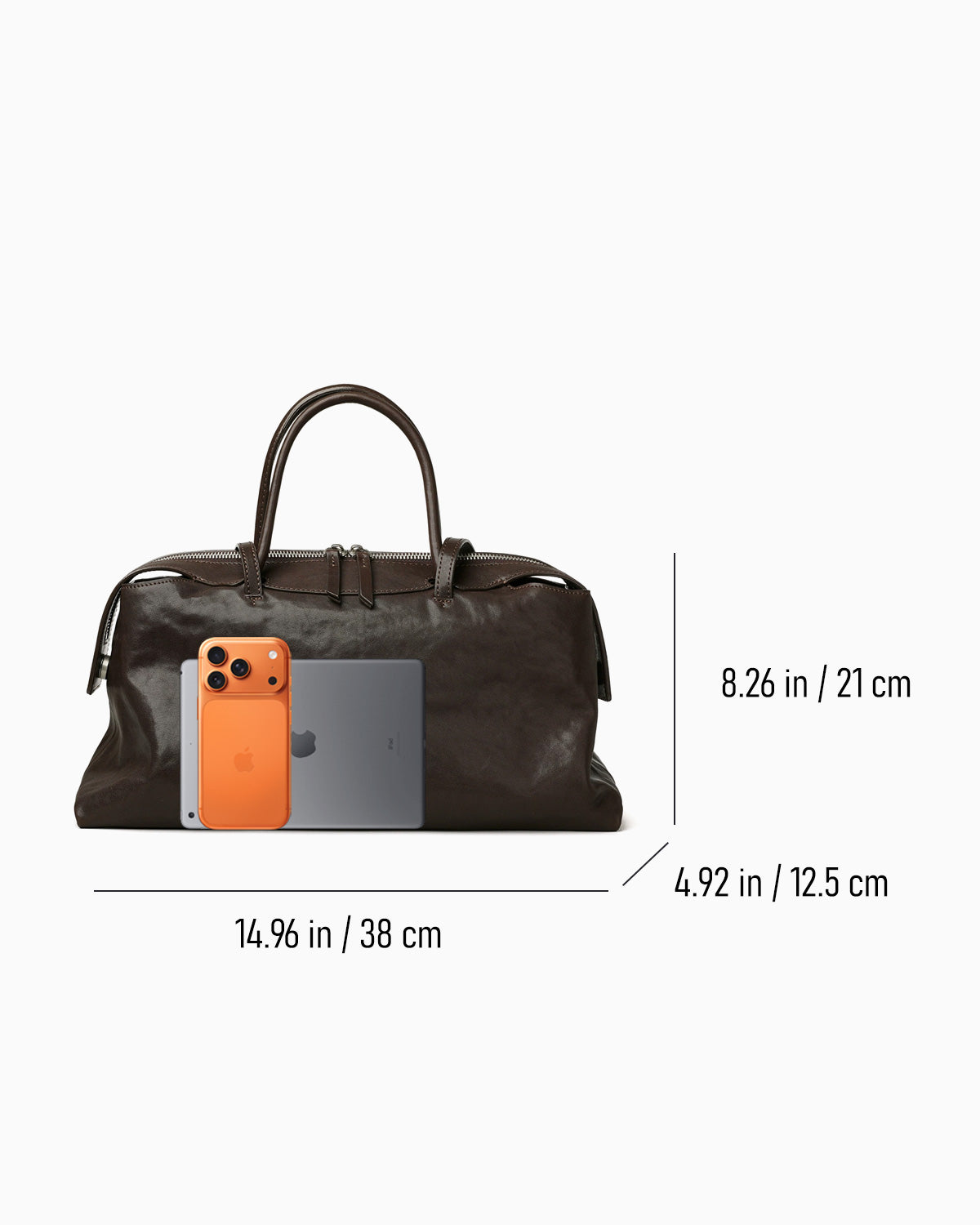 Dimensions of the Large Coffee-brown Leather Pillow Handbag with phone and tablet next to it for scale | BUCKLE Collective