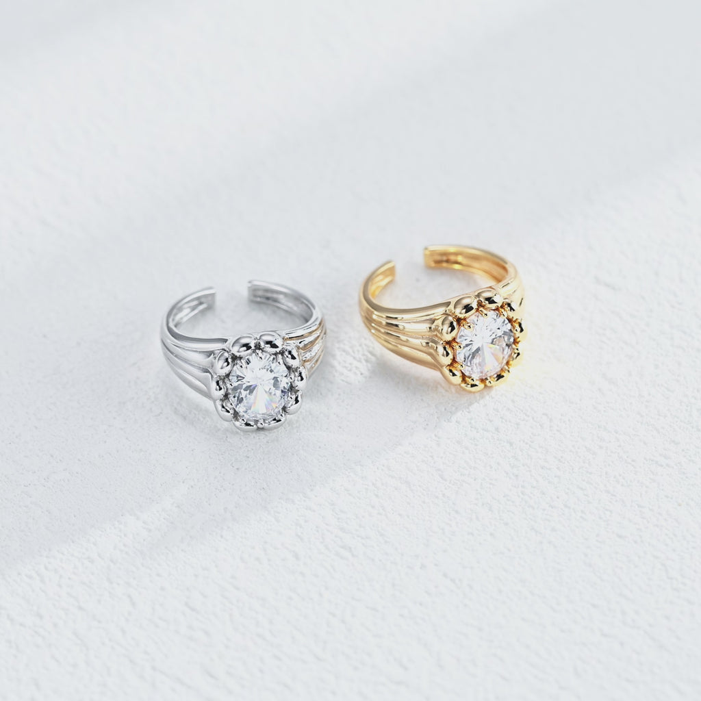 Sculptural round cubic zirconia open ring featuring a polished bead surround, grooved band and open cuff design.