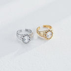 Sculptural round cubic zirconia open ring featuring a polished bead surround, grooved band and open cuff design.