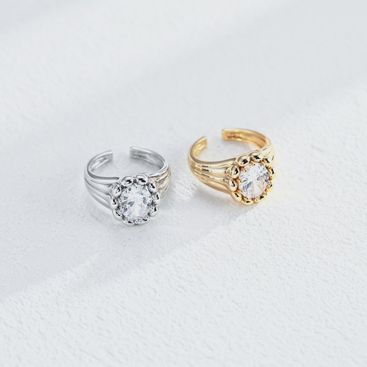 Sculptural round cubic zirconia open ring featuring a polished bead surround, grooved band and open cuff design.