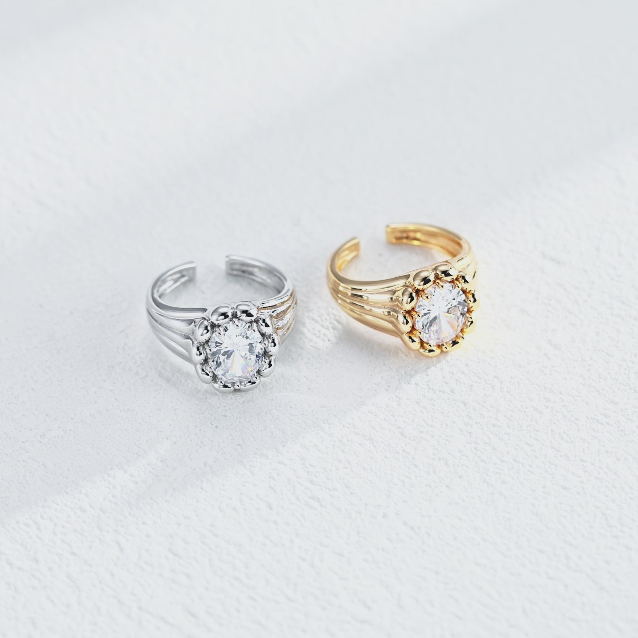 Sculptural round cubic zirconia open ring featuring a polished bead surround, grooved band and open cuff design.