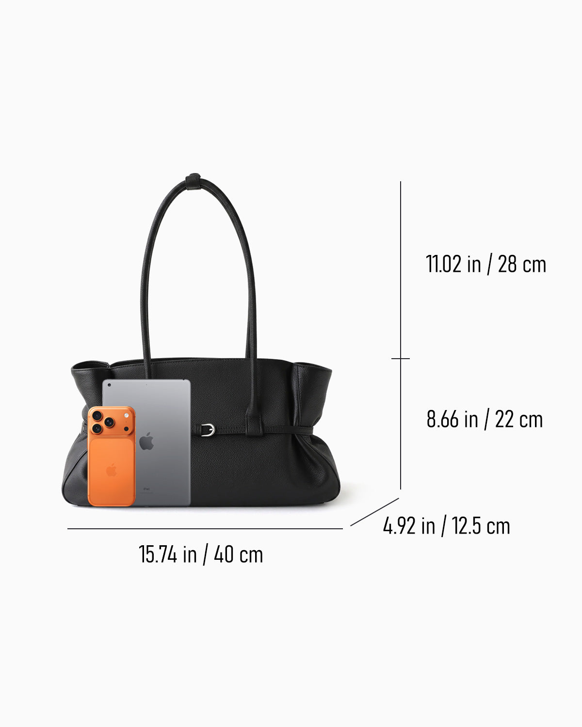 Black leather tote handbag shown with dimension lines and measurements indicating width, height, and depth, alongside a phone and tablet for scale | BUCKLE Collective