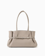A structured taupe leather handbag with a dual top handle, gathered side details, and a central strap with a silver buckle | BUCKLE Collective